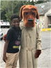 Mcgruff and child pose together