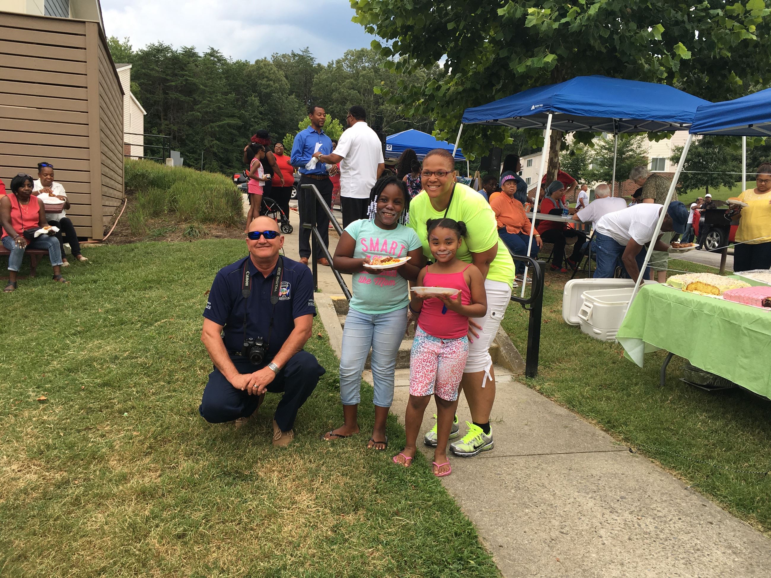 Police Office posing with A Women and Two children