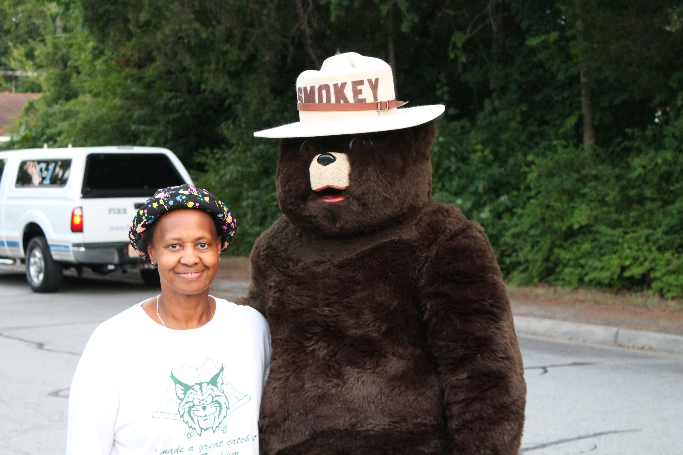 Women poses with Smokey the Bear 2017
