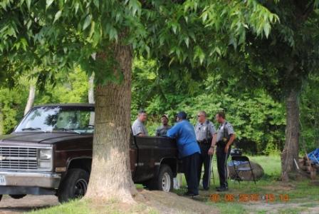 A group of men by truck