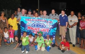 Community at National Night Out event with large banner